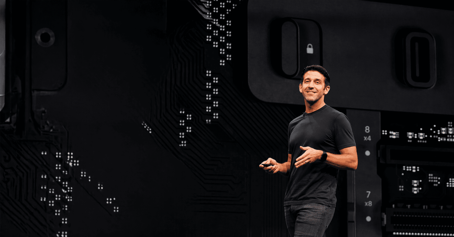 John Ternus speaking at Apple event as new CEO, wearing black t-shirt on stage